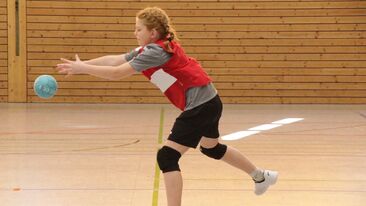 Jugendhandball Spielerin beim Passspiel mit dem Ball in der Sporthalle, Trainings- oder Spielsituation im Nachwuchs-Handballverein
